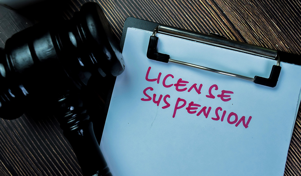 This is an image of a clipboard with a 'licence suspension' heading