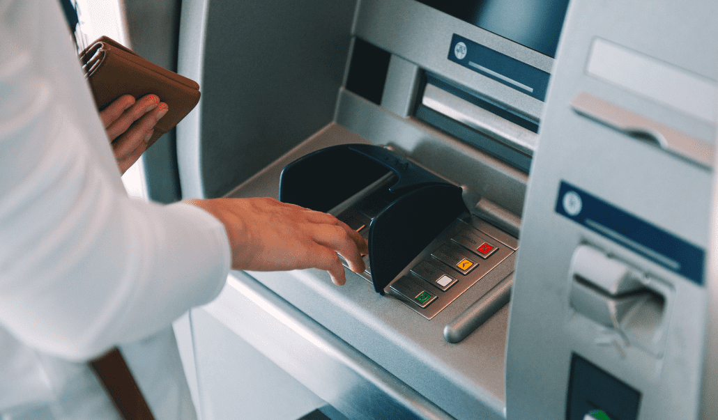 This is an image of a person using an ATM